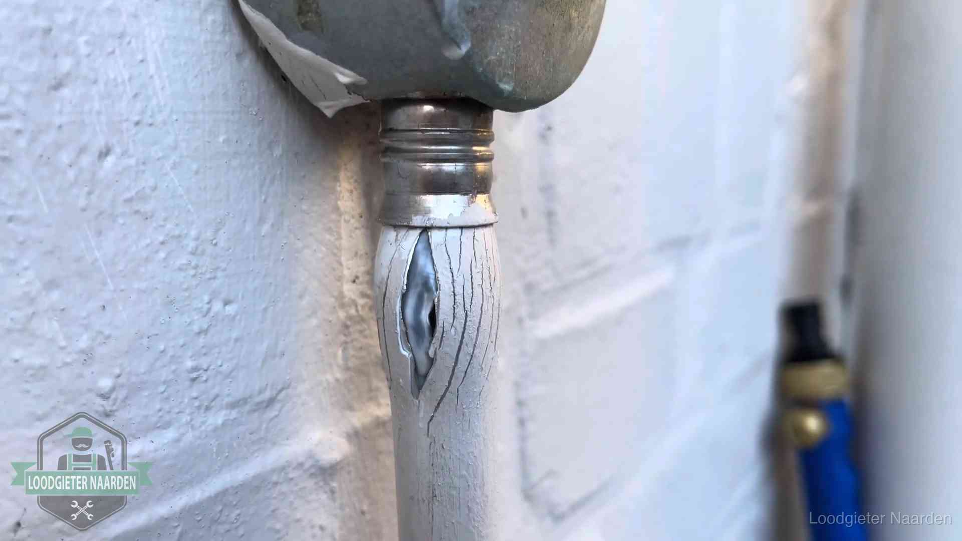 Oude waterleiding in Naarden waar de verf openscheurt, een stille aanwijzing voor een beginnend lek